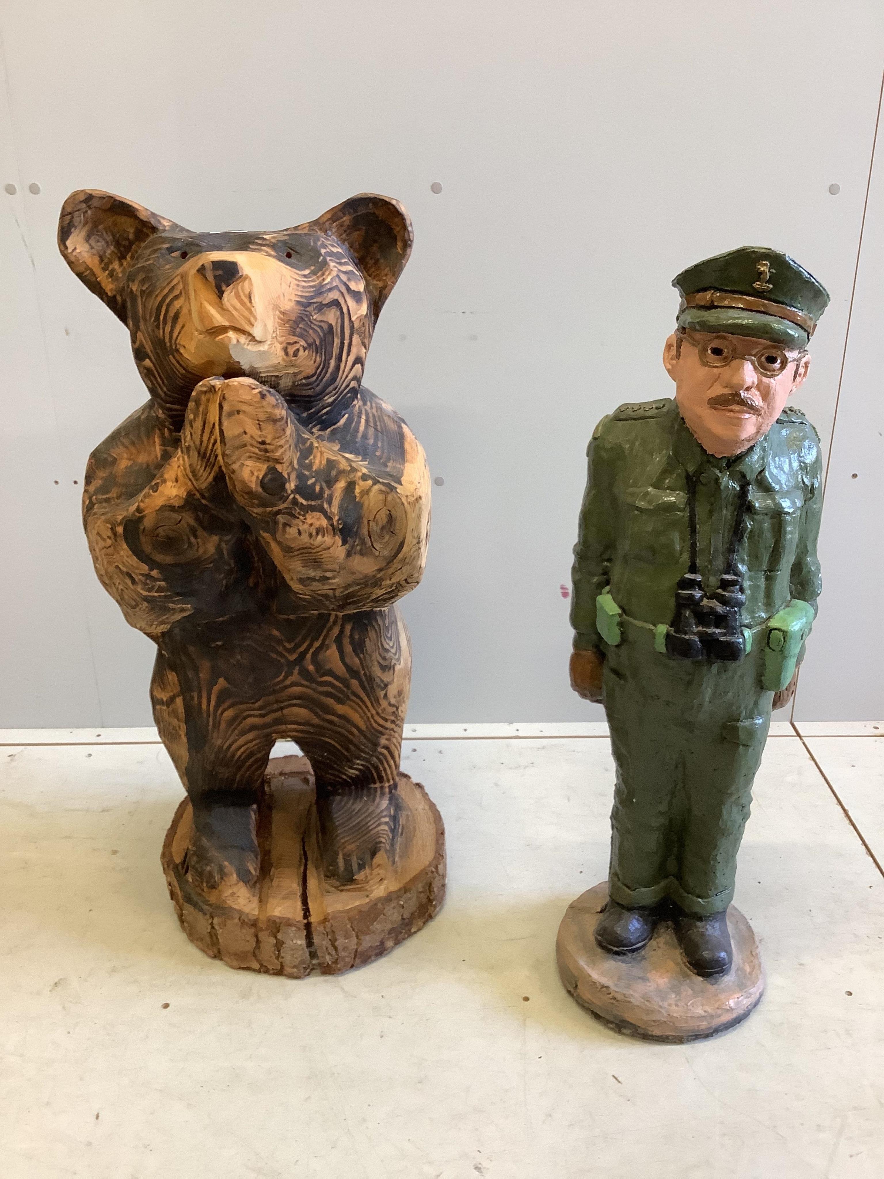 A garden chain saw carving of a standing bear together with a painted reconstituted stone Captain Manwaring garden ornament, larger height 93cm. Condition - fair